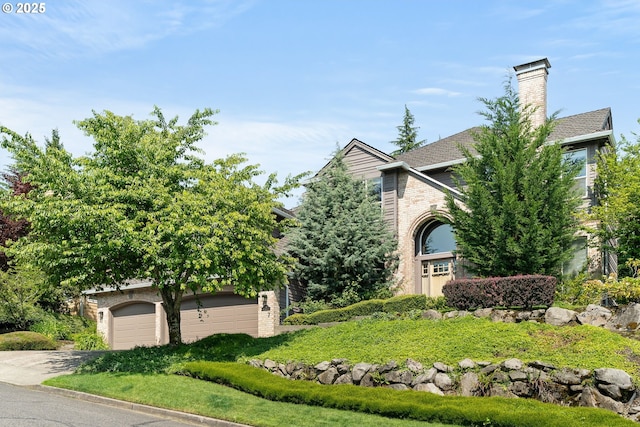 1314 NW Abernethy Rd, Portland, OR 97229 - obstructed view of property with concrete driveway and a chimney