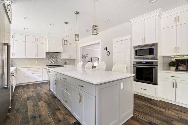 1314 NW Abernethy Rd, Portland, OR 97229 - kitchen with appliances with stainless steel finishes, premium range hood, tasteful backsplash, white cabinets, and recessed lighting