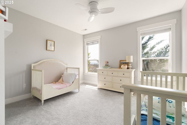1314 NW Abernethy Rd, Portland, OR 97229 - bedroom with multiple windows, carpet flooring, a nursery area, and ceiling fan
