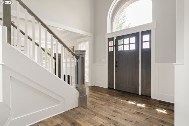 1314 NW Abernethy Rd, Portland, OR 97229 - entrance foyer with a decorative wall, a wainscoted wall, stairs, a high ceiling, and wood-type flooring