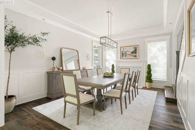 1314 NW Abernethy Rd, Portland, OR 97229 - dining room featuring a raised ceiling, dark wood-style floors, ornamental molding, a decorative wall, and a chandelier