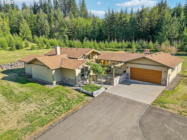 52135 E Terra Fern Dr, Sandy, OR 97055 - view of front of house featuring stone siding, concrete driveway, a garage, and a front yard