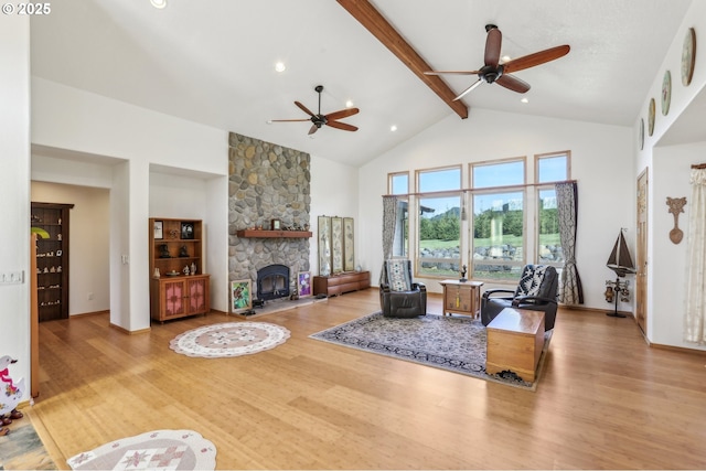 52135 E Terra Fern Dr, Sandy, OR 97055 - living room with a ceiling fan, beamed ceiling, high vaulted ceiling, wood finished floors, and a stone fireplace