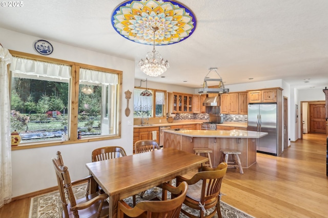 52135 E Terra Fern Dr, Sandy, OR 97055 - dining space featuring light wood finished floors and a chandelier