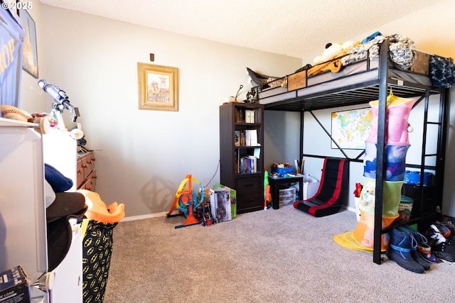 bedroom with carpet, baseboards, and a textured ceiling