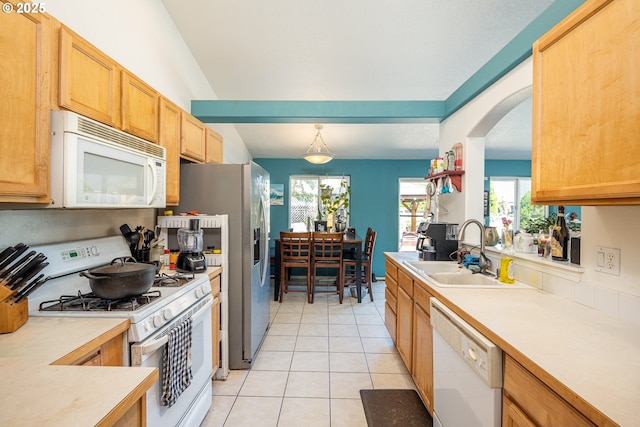 1280 Peets Ct, Eugene, OR 97402 - kitchen with white appliances, light tile patterned floors, arched walkways, light countertops, and pendant lighting