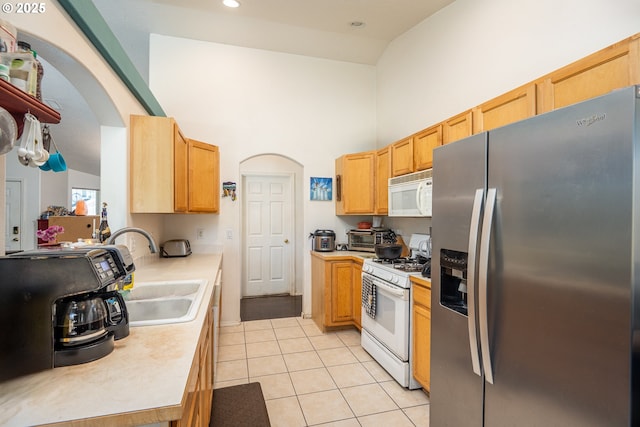 1280 Peets Ct, Eugene, OR 97402 - kitchen featuring white appliances, high vaulted ceiling, arched walkways, light tile patterned floors, and light countertops