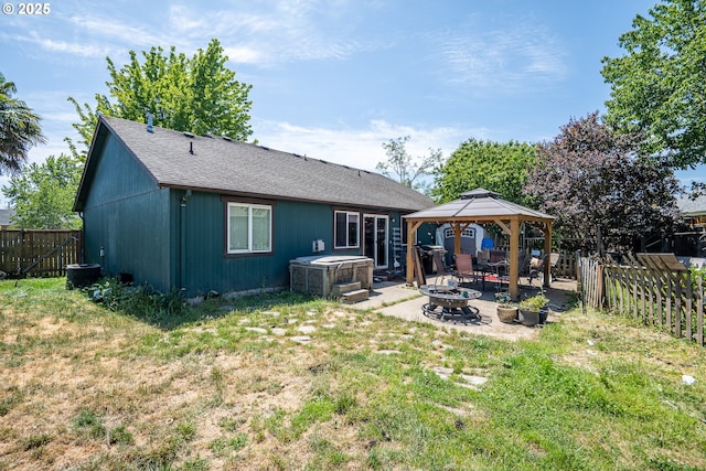1280 Peets Ct, Eugene, OR 97402 - back of house with a hot tub, a gazebo, a patio area, a fenced backyard, and an outdoor fire pit