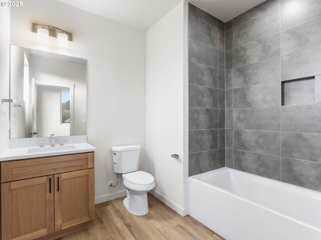 full bathroom featuring vanity, toilet, wood finished floors, and baseboards