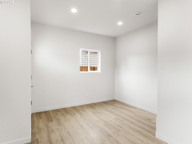 unfurnished room featuring recessed lighting, baseboards, and wood finished floors
