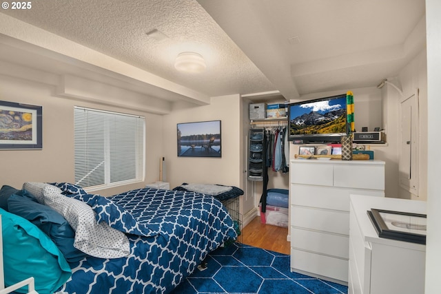 bedroom with a closet and a textured ceiling