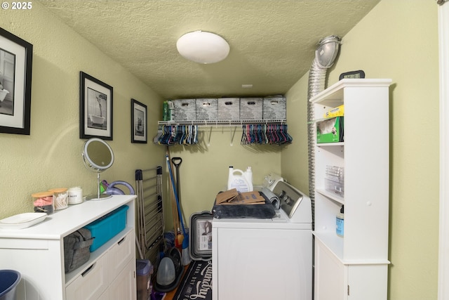 clothes washing area featuring separate washer and dryer, laundry area, and a textured ceiling