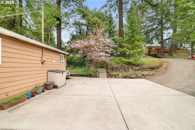 view of patio / terrace with driveway and stairway