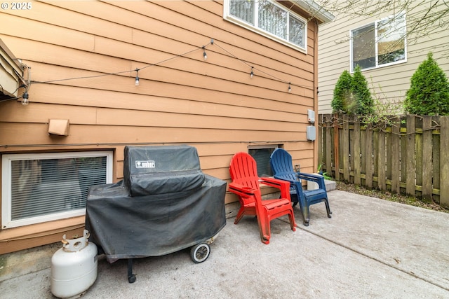 view of patio / terrace with area for grilling and fence
