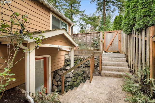 view of home's exterior with a gate and fence
