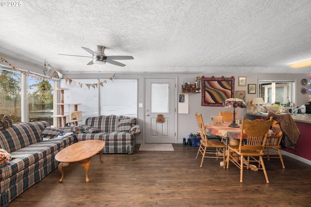 living area featuring a textured ceiling, ceiling fan, and wood finished floors