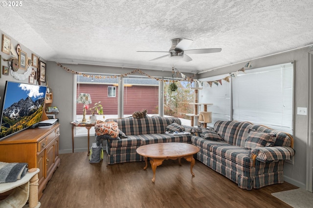 living room featuring a textured ceiling, a healthy amount of sunlight, wood finished floors, and a ceiling fan