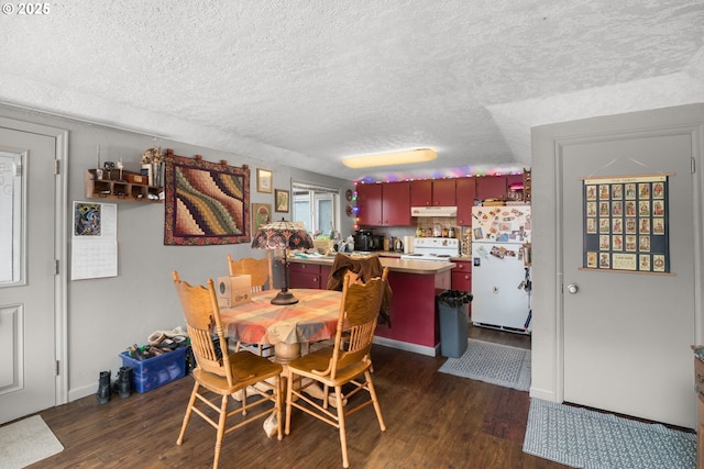 dining area with a textured ceiling, baseboards, and dark wood-style flooring