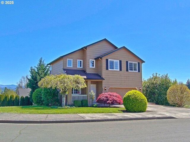 800 NW Magnolia St, Camas, WA 98607 - view of front of home with an attached garage, covered porch, and concrete driveway
