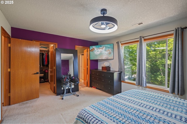 4055 NE 13th Ter, Gresham, OR 97030 - bedroom with carpet flooring, a spacious closet, a textured ceiling, and a closet
