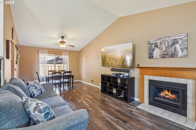 4055 NE 13th Ter, Gresham, OR 97030 - living room with lofted ceiling, a tiled fireplace, wood finished floors, a ceiling fan, and baseboards