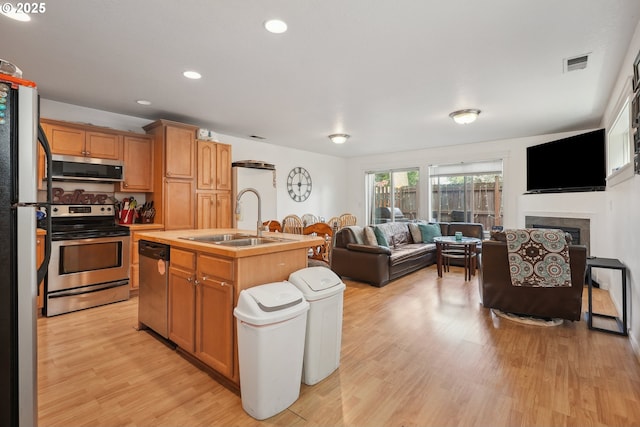 12631 SE Division St, Portland, OR 97236 - kitchen with open floor plan, light wood-style floors, visible vents, appliances with stainless steel finishes, and a sink