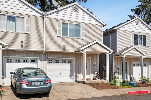 12631 SE Division St, Portland, OR 97236 - townhome / multi-family property featuring concrete driveway, board and batten siding, and an attached garage