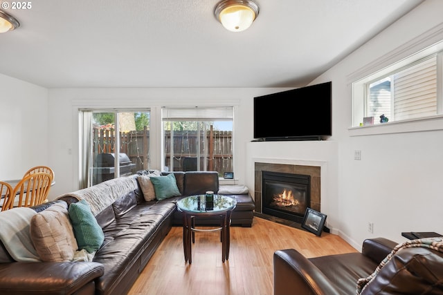 12631 SE Division St, Portland, OR 97236 - living room featuring a tile fireplace and light wood finished floors