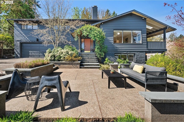 2631 SW Sherwood Dr, Portland, OR 97201 - rear view of house with outdoor lounge area, a chimney, a patio area, and a garage
