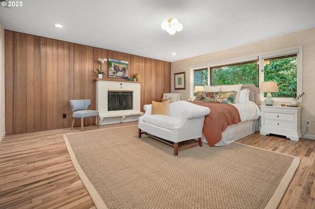 2631 SW Sherwood Dr, Portland, OR 97201 - bedroom with wood walls, wood finished floors, and a fireplace