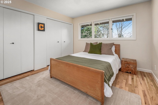 2631 SW Sherwood Dr, Portland, OR 97201 - bedroom with a closet, baseboards, and wood finished floors