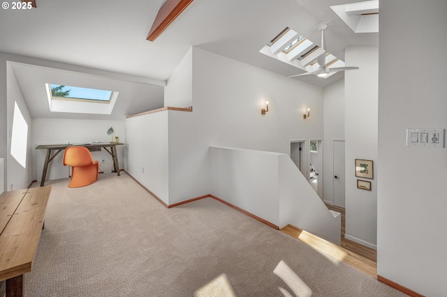2631 SW Sherwood Dr, Portland, OR 97201 - additional living space featuring a skylight, high vaulted ceiling, baseboards, and carpet