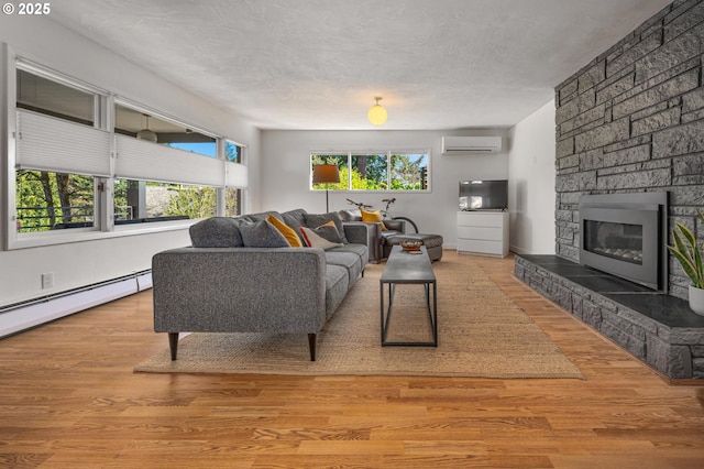 2631 SW Sherwood Dr, Portland, OR 97201 - living area with wood finished floors, a wall mounted air conditioner, a fireplace, and a baseboard heating unit