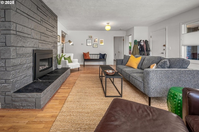 2631 SW Sherwood Dr, Portland, OR 97201 - living room with a wealth of natural light, a textured ceiling, wood finished floors, and a fireplace