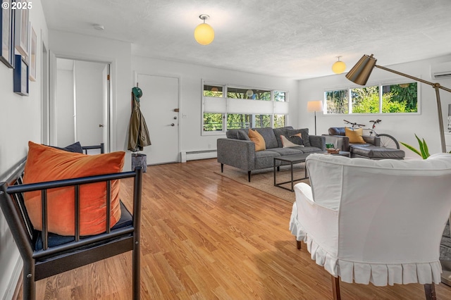 2631 SW Sherwood Dr, Portland, OR 97201 - living area featuring light wood-type flooring, a baseboard heating unit, and a healthy amount of sunlight