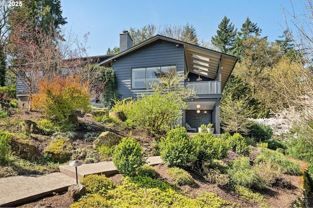 2631 SW Sherwood Dr, Portland, OR 97201 - view of front of home featuring a chimney and a balcony