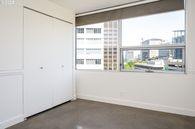 1500 SW 5th Ave Unit 703, Portland, OR 97201 - unfurnished bedroom featuring baseboards, a closet, and a view of city