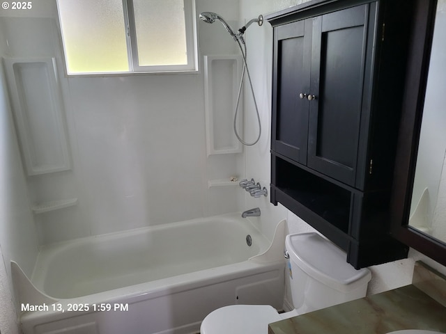 bathroom featuring shower / bathing tub combination and toilet