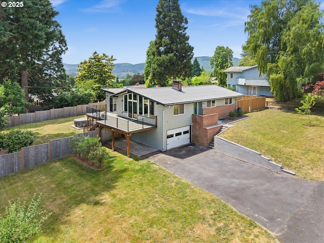 620 Sky Ln, Forest Grove, OR 97116 - view of front facade featuring an attached garage, a chimney, asphalt driveway, a tiled roof, and a deck with mountain view