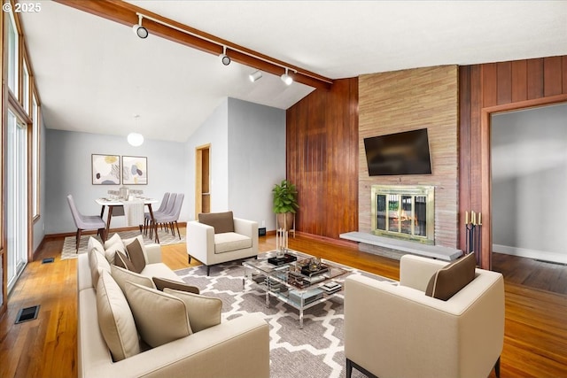 620 Sky Ln, Forest Grove, OR 97116 - living area with wood finished floors, a fireplace, rail lighting, and wood walls