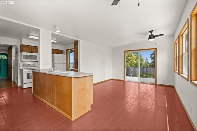 620 Sky Ln, Forest Grove, OR 97116 - kitchen featuring white appliances, ceiling fan, light countertops, open floor plan, and dark tile patterned floors