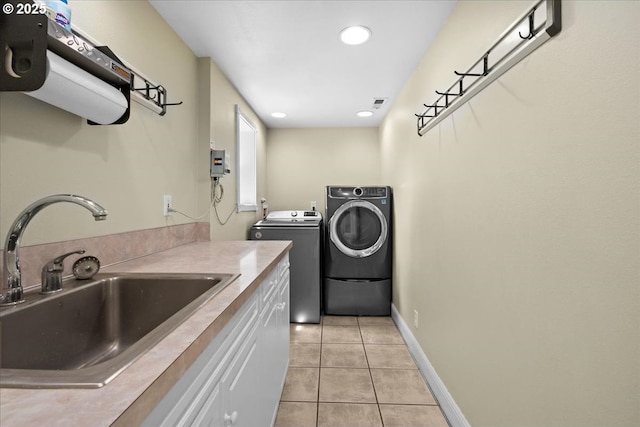 620 Sky Ln, Forest Grove, OR 97116 - laundry room with washing machine and clothes dryer, cabinet space, light tile patterned floors, and recessed lighting