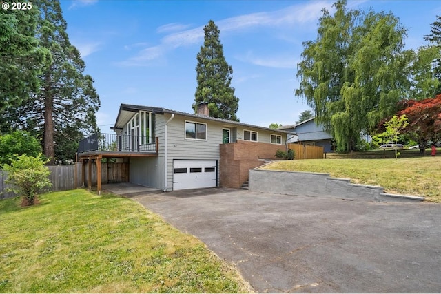 620 Sky Ln, Forest Grove, OR 97116 - view of front of house featuring asphalt driveway, a chimney, a garage, and a wooden deck