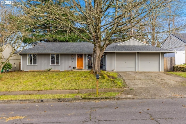 ranch-style house featuring a garage, a front yard, and driveway