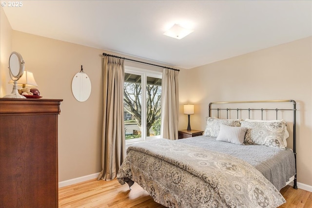 bedroom with baseboards and light wood finished floors