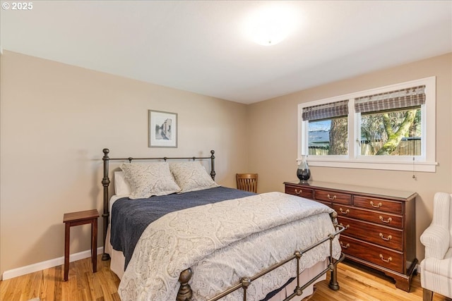 bedroom with baseboards and light wood-style floors