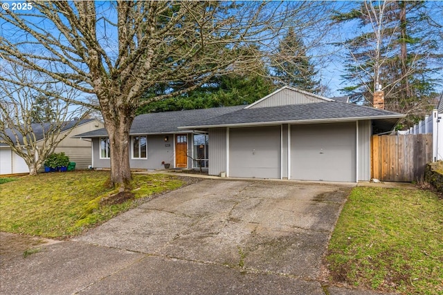 ranch-style home with an attached garage, a front lawn, fence, roof with shingles, and driveway