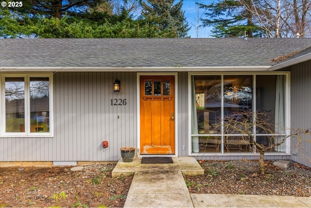 property entrance with a shingled roof