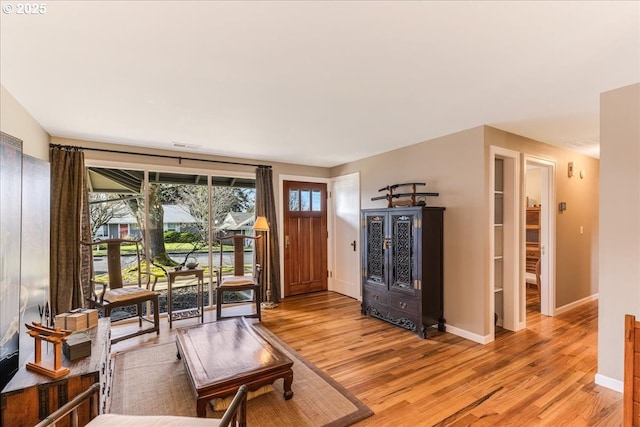 living area with light wood-style floors and baseboards