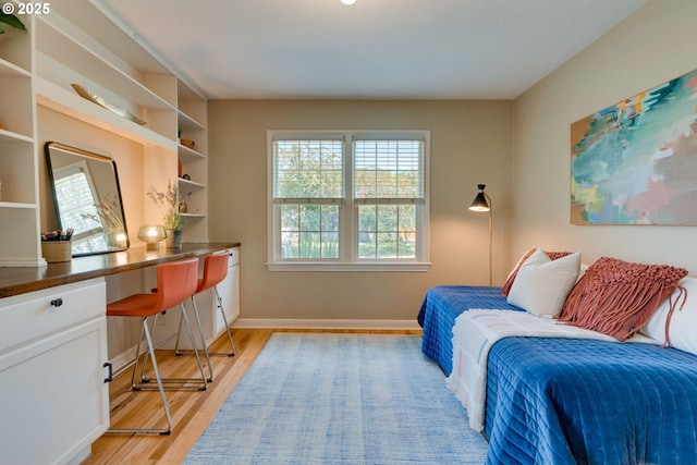 7067 N Dwight Ave, Portland, OR 97203 - bedroom featuring built in desk and light wood-type flooring
